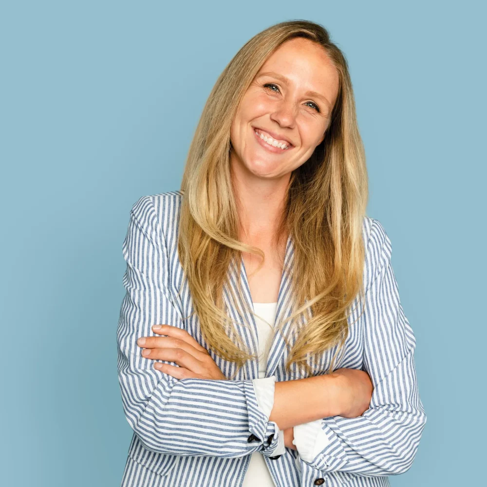 TourDent confident smiling woman with arms crossed happy with dental treatment results